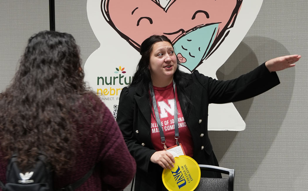 Students share Nurture Nebraska with conference attendees.